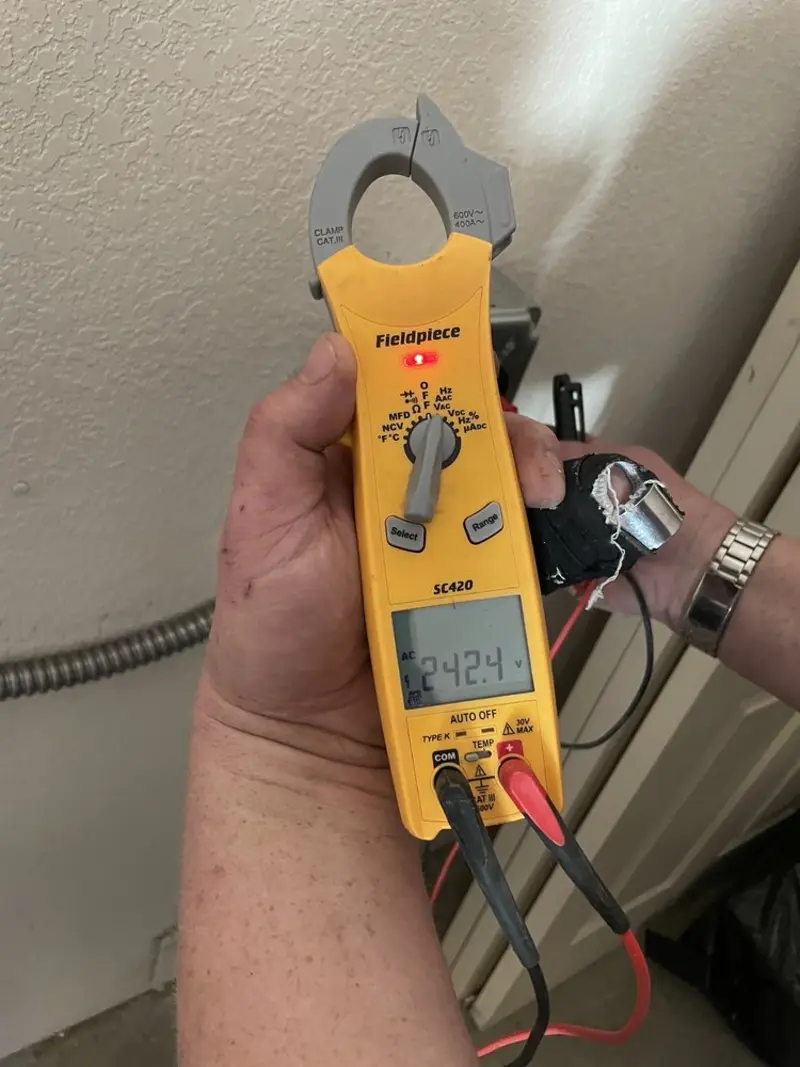 Voltage testing with clamp meter during Outlet Installation in Menominee